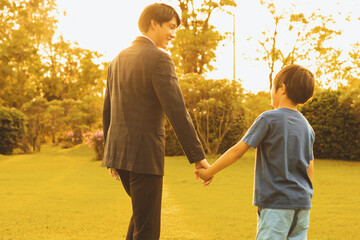 Visionary and eco conscious businessman father guide his son to the bright future with sunset...