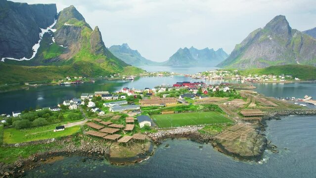 aerial view of soccer field in Lofoten Island. Drone shot of Reine fishing village in Norway. Norwegian summer tourism. 
