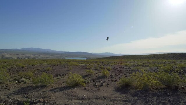 Jetpack man flies over desert 