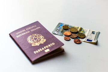 Italian passport lon the table and few euro money