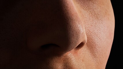 Macro profile of young woman n a black background. Human nose close-up. Human skin. A shadow falls on the face.