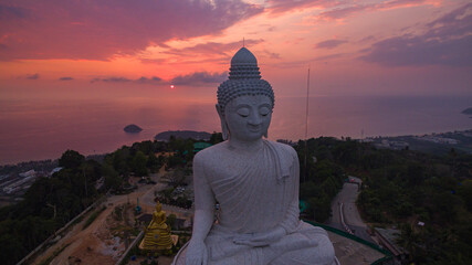 .aerial view stunning pink sky in sweet sunset at Phuket big Buddha. .the sun shines through the...
