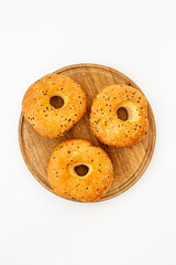Set of fresh bread bagels on wooden board, top view