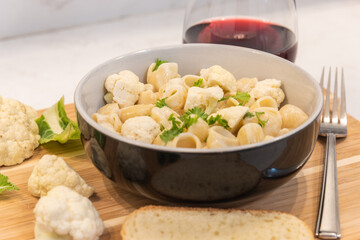 Cauliflower Mac and Cheese in bowl on cutting board