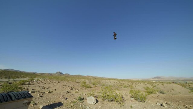 Human flying above the ground with jet pack