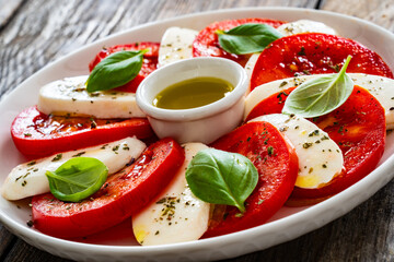 Caprese salad on wooden table
