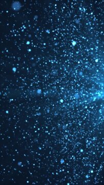 Vertical video - abstract background animation with glittering shiny blue particles and shimmering light rays. This sparkling motion background animation is full HD and a seamless loop.