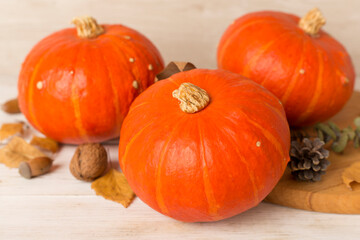 Orange pumpkins with autumn decor on table