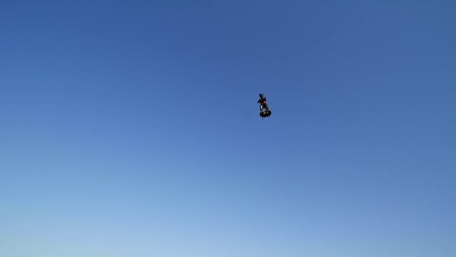 Blue skies with flying man hovering above