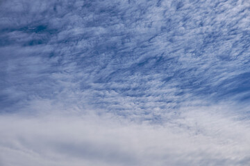 Naklejka na ściany i meble A blue sky full of white clouds, sunny day