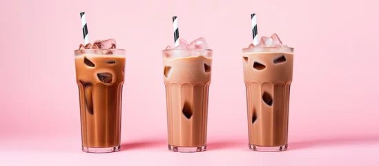 Küchenrückwand glas motiv Refreshing summer drink iced coffee milk tall glasses pink background © TheWaterMeloonProjec
