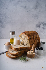 Fresh Sliced Homemade Wholegrain Wheat Bread on white rustic background. Artisan Sourdough