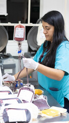 Young woman of Latin and professional appearance processing donated blood to save patients' lives.