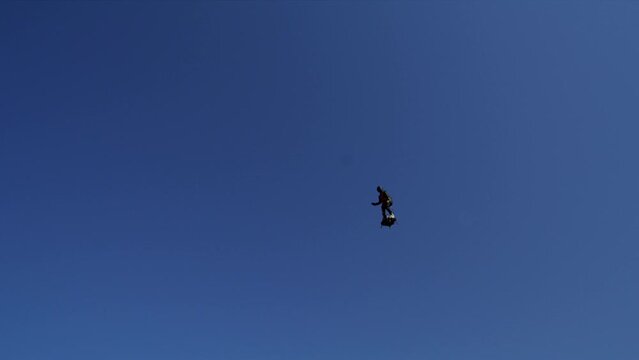 Man flies over with jet engine hooked to feet