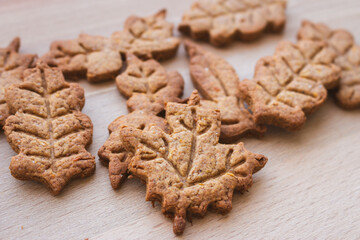 Autumn leaf shaped cookie of gingerbread dough. Autumn festive cookies. Handmade bakery....