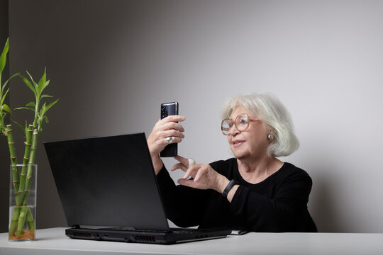 Older Woman Taking A Selfie In Front Of The Laptop