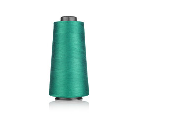 spool of industrial thread green color, texture of thread on a white background