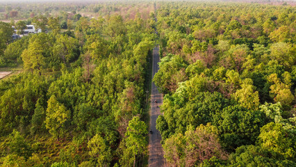 Obraz premium Aerial view of Asphalt Highway passing through autumn lush forest in Nepal