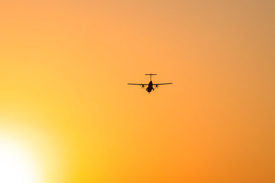 Silhouette of an ATR 72-500 Turboprop Aircraft against sunset