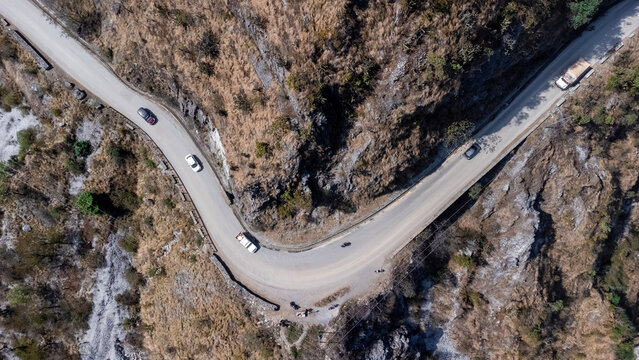 Top-Down View of a Winding Mountain Highway with Traffic in Nepal