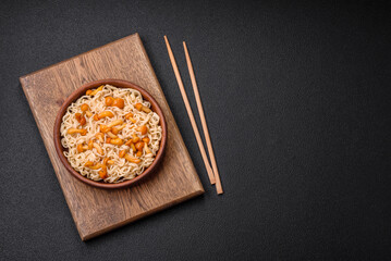 Delicious Asian cuisine dish with rice noodles, peppers, mushrooms and spices
