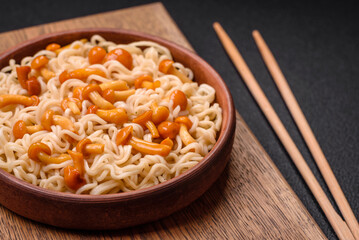 Delicious Asian cuisine dish with rice noodles, peppers, mushrooms and spices