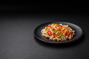 Delicious Asian cuisine dish with rice noodles, peppers, mushrooms and spices