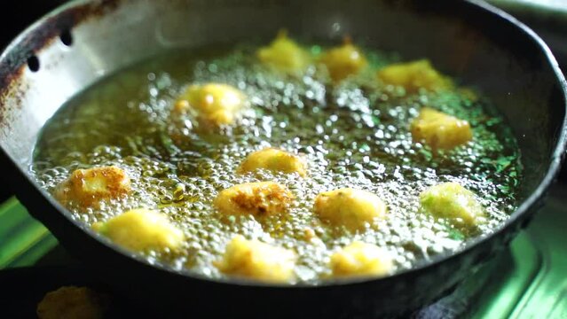 Indian young Woman Preparing Pakoda or pakora for guest