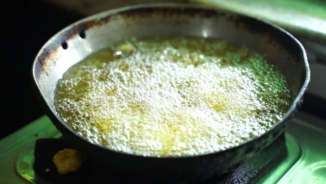Indian young Woman Preparing Pakoda or pakora for guest