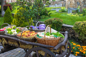 Agricultural exhibition in a retro cart of vegetables, fruits, root vegetables and herbs.