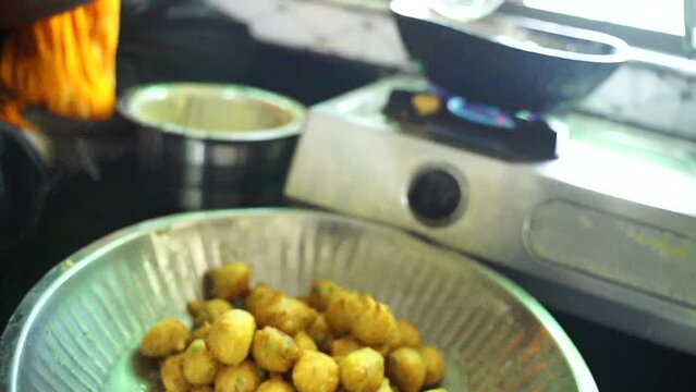 Fried pakoras are stored in a pot after frying
