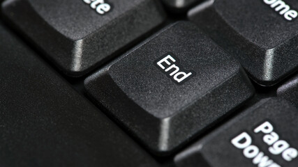 End key on a desktop PC office computer keyboard, the end button macro, detail, extreme closeup. Ending, finishing, closing or stopping a process, It's over abstract concept, technology equipment