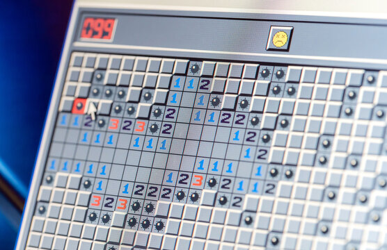 Microsoft Windows XP classic Minesweeper game opened on an old retro laptop, display closeup detail. Classic video games culture abstract concept, digital entertainment
