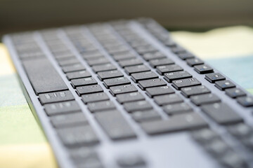 Simple modern wireless computer keyboard abstract background, shallow depth of field, object closeup detail slide presentation blurry background, blurred backdrop wallpaper, copy space, nobody, coding
