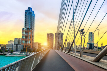 Pedestrian and cycle path on bridge in Rotterdam city at sunset, the Netherlands.