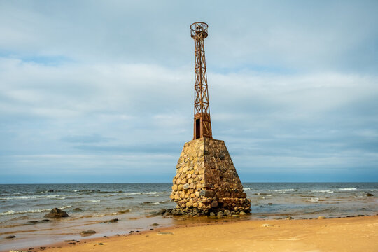 The old Kurmraga lighthouse on the coast of the Baltic Sea. Autumn day in Latvia Riga Gulf