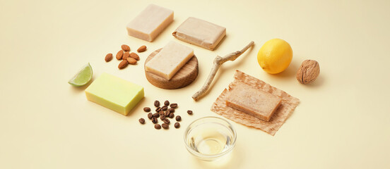 Composition with soap bars and natural ingredients on beige background