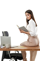 business woman holding notebook and sitting on table