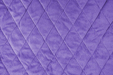 Quilted velours fabric background. Purple texture blanket or puffer jacket, stiched with diamond...