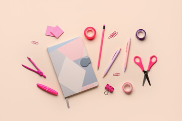 Composition with notebook and stationery supplies on pink background