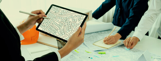 Worker, architect and engineer work on real estate construction project oratory planning with...