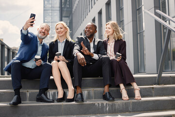 Business people sitting on a stairs and make a selfie