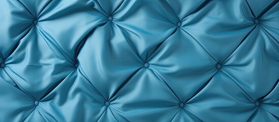 Closeup top view of a fitted sheet in blue on a mattress