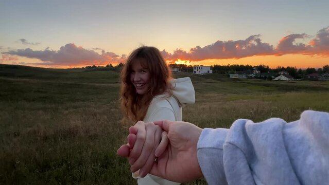 young cute woman dreaming and praying outdoors at sunset or sunrise in the park