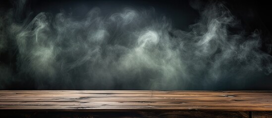 Smoke seen in dark background near old wooden table