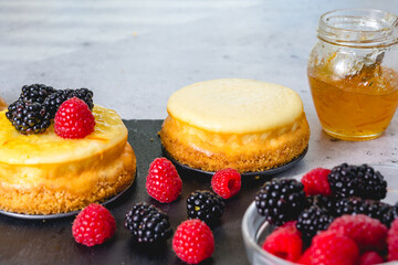 Cheesecake with fresh raspberries and blackberries close-up. Homemade mini cheesecakes recipe