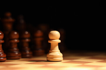 Game board with chess pieces on dark background, closeup