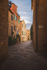 Charming and quaint narrow old town backstreet in in the historic Tuscan village of Pienza, Tuscany.