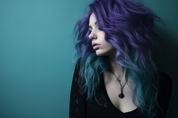 Pensive young girl with purple hair in front of a dark and turquoise background.