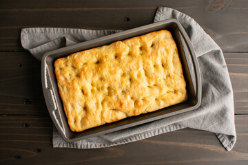 Freshly Baked Focaccia Bread in a Shallow Pan: Freshly baked Italian peasant bread in a metal...